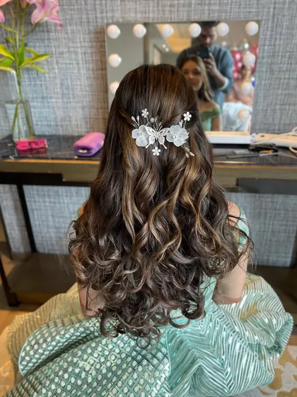 Another angle of the half updo, showing the delicate, butterfly like hair accessory.