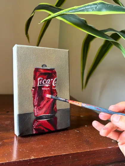 Finding beauty in everyday objects is a passion of mine. This realistic oil painting of a crushed Coca-Cola can is a perfect example of turning the mundane into a piece of pop art.