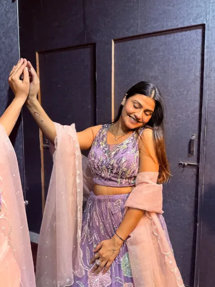 A candid shot of a client enjoying her look in the lavender floral lehenga.