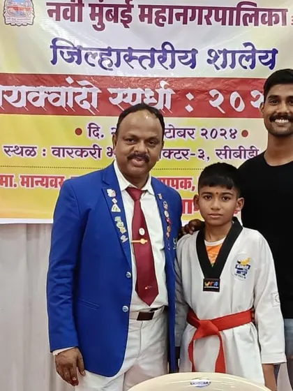One of my young champions with officials after a successful competition. We ensure our students are prepared to compete with confidence at every level, from local to district tournaments.