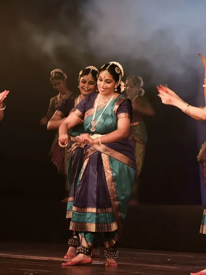 A joyous moment in the dance, reflecting the celebratory nature of the performance.