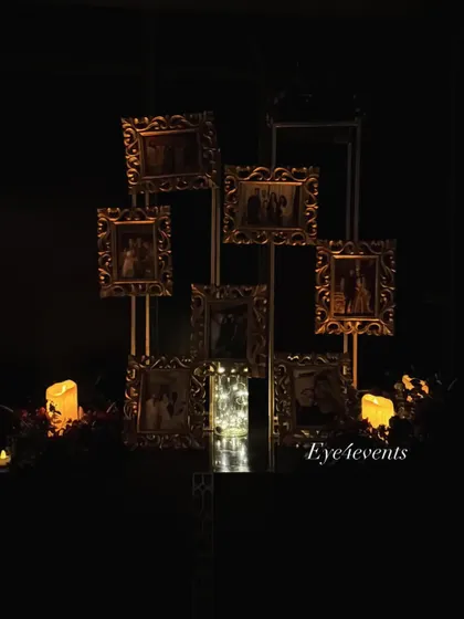 To add a personal touch to an event, I created this memory display. It features multiple family photos in ornate golden frames, artfully arranged on stands and illuminated by candles and fairy lights in the dark.