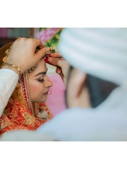 A close-up of the sindoor ceremony, a deeply significant wedding ritual.