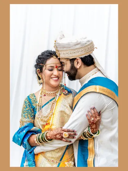 A tender and intimate moment between a Maharashtrian bride and groom. The groom's gentle embrace and the bride's happy smile say it all.