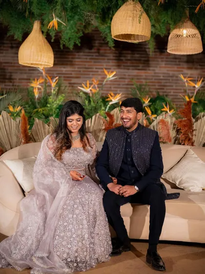 A candid moment of laughter between Yeshaswini and Shashank. We designed a boho-chic backdrop with cane lanterns and birds of paradise that perfectly matched their relaxed and happy vibe.