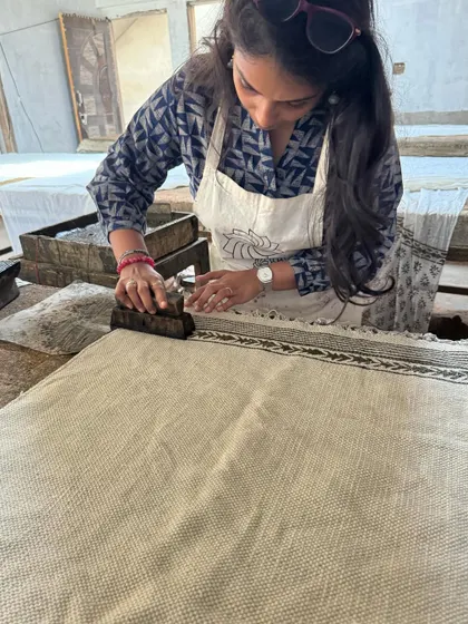 Here I am learning the Dabu printing process, applying the mud-resist paste with a block before the fabric is dyed. It's a fascinating and complex technique that yields beautiful results.