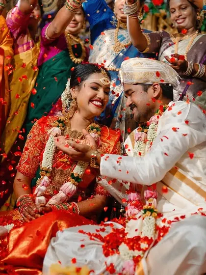 This is what pure joy looks like. We love capturing the peak moments of a South Indian wedding ceremony, like this traditional akshatharopanam ritual, where the couple is showered with blessings, rice, and flower petals.