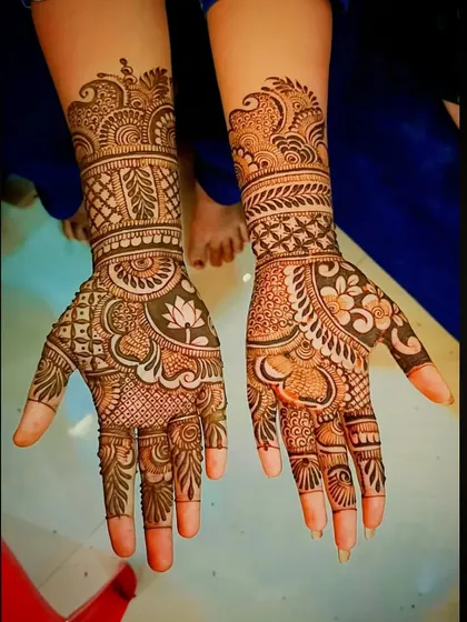 This design features a beautiful lotus on the palm, surrounded by a mix of fine-line fillers and bold traditional patterns.