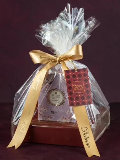 This Diwali hamper is a perfect gesture of love, featuring our handmade assorted dry fruit chocolates and a beautiful scented candle, all wrapped up for the occasion.