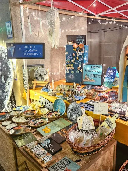 Our stall at night, all lit up with fairy lights. We love creating a magical little corner to display our art, from the moon installations to the small hand-painted plates.