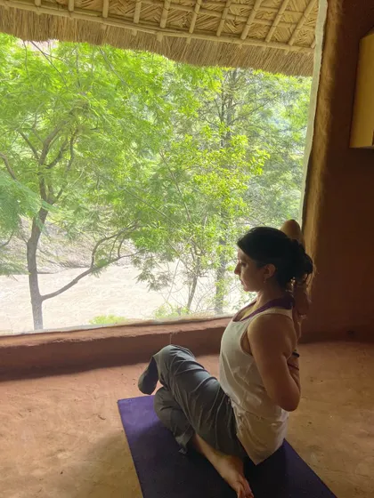 Practicing a seated twist, a photo from my late 30s. My personal practice has evolved over the decades, but the core principles of breath and alignment remain constant.