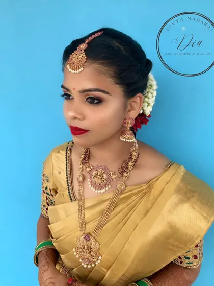 A classic South Indian bridal look featuring a beautiful gold saree. I created a bold look with smokey eyes, a classic red lip, and traditional temple jewellery. The hair is styled in a neat bun adorned with fresh jasmine flowers.