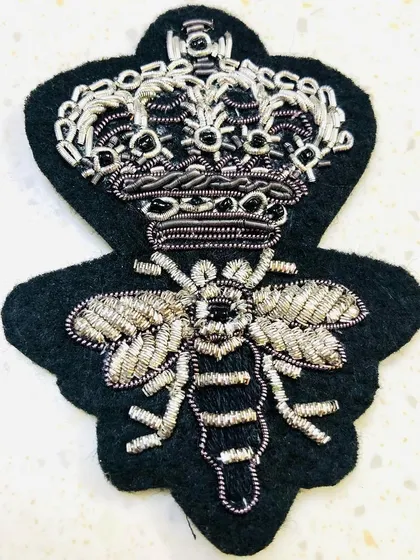 A close-up of the silver crowned bee patch, highlighting the detailed zari and beadwork. This appliqué can be sewn onto a shirt, blazer, or bag to instantly upgrade its style.