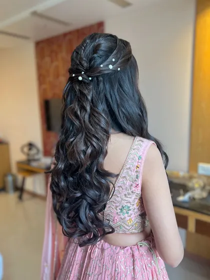 A classic half-updo with a braided detail and scattered pearls, a pretty and popular choice.