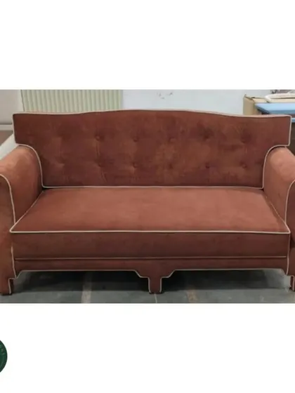 A straight-on shot of the terracotta sofa in our workshop, emphasizing its solid construction and balanced proportions before it heads to its new home.