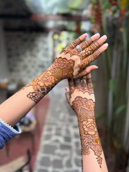 A beautiful shot of the non-bridal henna, showing how the design flows from the hand up the arm.