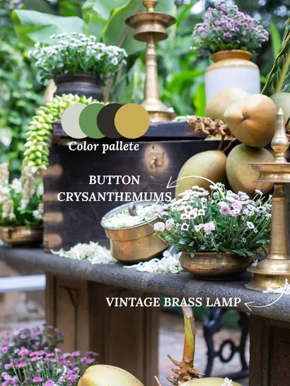 A vintage brass lamp and button chrysanthemums create a charming, rustic corner. We use elements like tender coconuts and antique pieces to add an authentic, earthy feel to our South Indian decor.