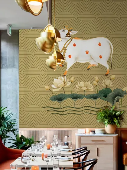 This restaurant setting is enhanced by the cultural and spiritual significance of our Sacred Indian Traditional Pichwai Cow wallpaper. It creates a unique and memorable dining atmosphere for guests.