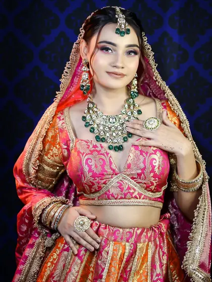 The full look, featuring a multi-toned lehenga with intricate embroidery. Our students learn to analyze the entire look to create complementary makeup.