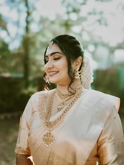 A serene close-up. Her skin looks flawless and dewy, a testament to the detailed skin prep and careful application that goes into every bridal look.