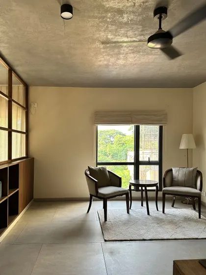 A quiet seating nook on the upper level, with a view of the trees outside. These small, thoughtful spaces are essential for creating a comfortable home.