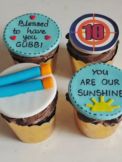 These Nerf gun themed cupcakes were designed for a 10th birthday party. The custom fondant toppers include a target, Nerf darts, and sweet messages for the birthday boy.