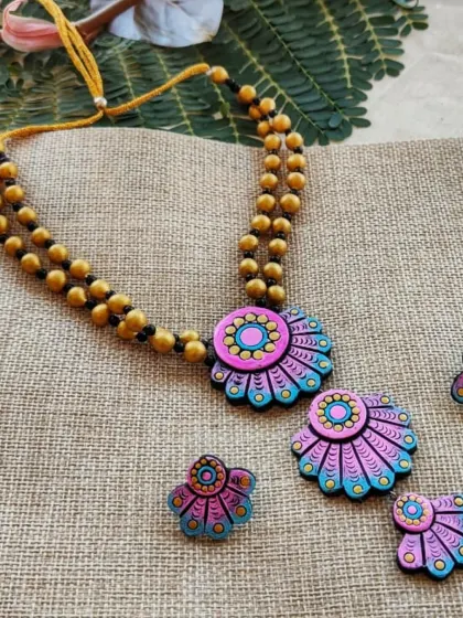 The same three-layered floral necklace in a cool baby pink and sky blue combination. This softer palette is great for daytime events and summer collections.