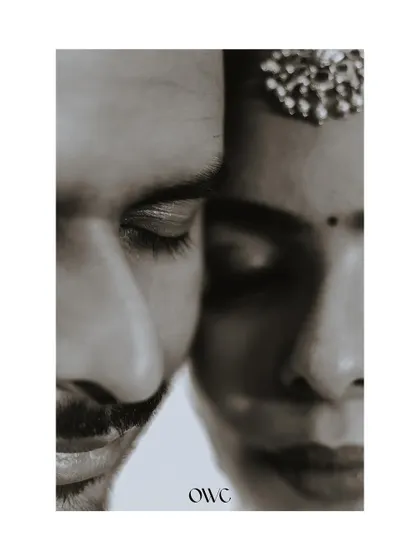 An artistic and intimate black and white close-up of a couple, focusing on their features and connection.