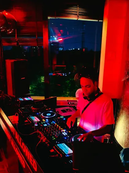 Mixing live in a dark, atmospheric club. My goal is to create an immersive experience where you can forget everything and just dance.