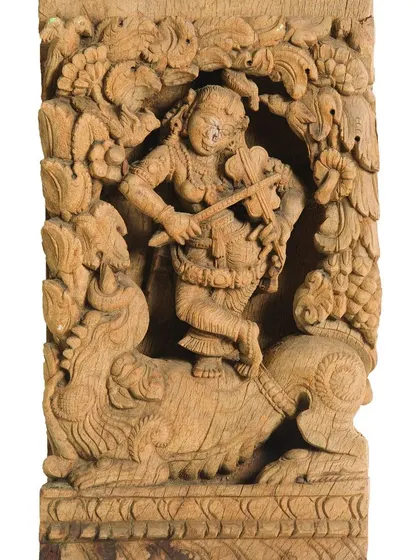 Our work extends beyond canvases to three-dimensional heritage objects. This intricately carved wooden panel, depicting a celestial musician, is one of over 200 pieces from a 100-year-old temple chariot that we painstakingly documented and restored over two years.