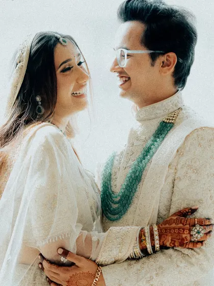 A moment of pure, candid happiness. The couple's shared laughter and loving embrace make this a heartwarming and genuine portrait of their wedding day joy.