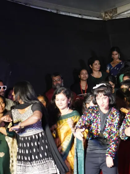 A candid shot from backstage, celebrating with the performers. The energy and camaraderie are what make group dances so special. I can help your family and friends build this bond through dance.