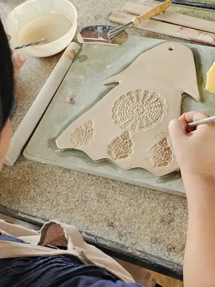 A few snapshots of corporate team members completely absorbed in their creative process. They are making everything from decorative nameplates to unique bowls during our hand-building workshop.