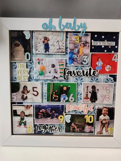 A square view of the baby's first-year milestone frame, showing the arrangement of 12 photos from month 0 to 11.