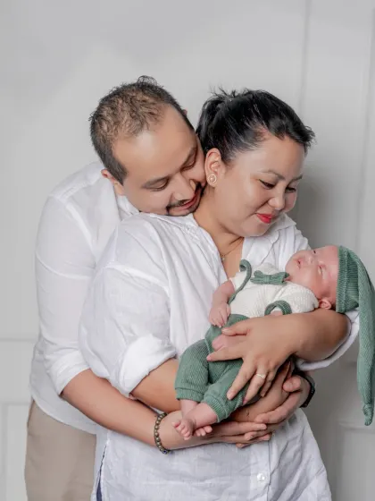 A quiet moment of love and adoration. I aim to capture the candid, loving glances between new parents as they embrace their baby and each other.