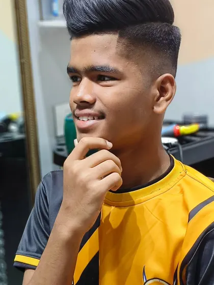 This young man is looking sharp and confident with his new haircut.