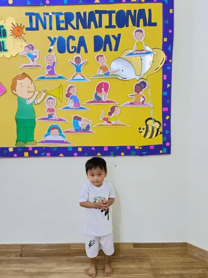 This little boy joins in the International Yoga Day celebration, showing his focus and calm. Yoga is for everyone at Purple Asters.