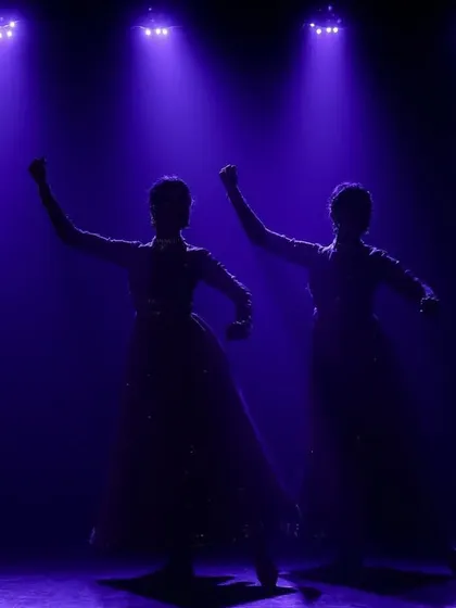 A strong, powerful silhouette against the purple lights. This pose conveys strength and confidence.