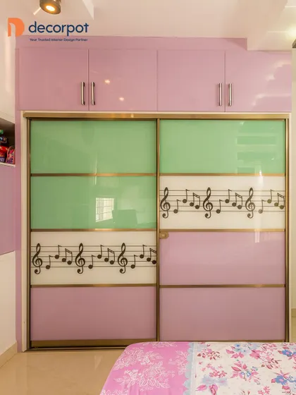 For a child's room or a music lover, this custom sliding wardrobe features musical notes on the panels. The playful design is set against a lovely lavender and mint green color scheme.