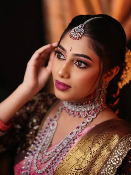 A profile shot that highlights the contour of the face and the elegant line of the jaw. The makeup enhances the bride's natural bone structure.
