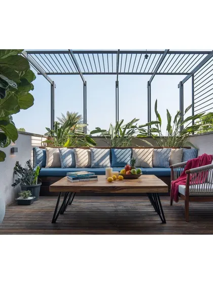 The terrace lounge is perfect for enjoying the Bangalore weather, with a mix of custom and curated furniture creating a relaxed vibe.