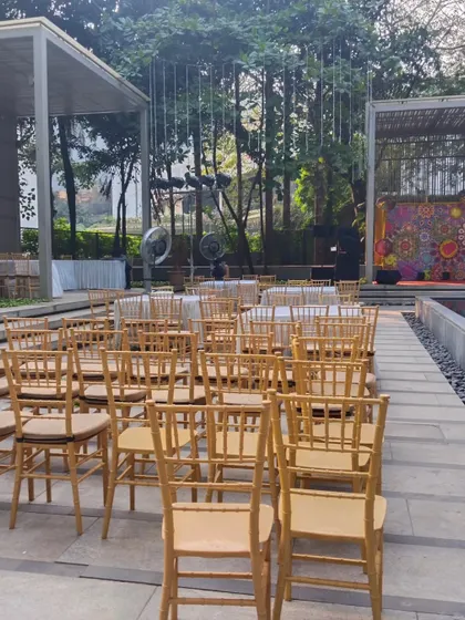 The seating arrangement for the poolside corporate event, featuring elegant Tiffany chairs arranged for a presentation or show.