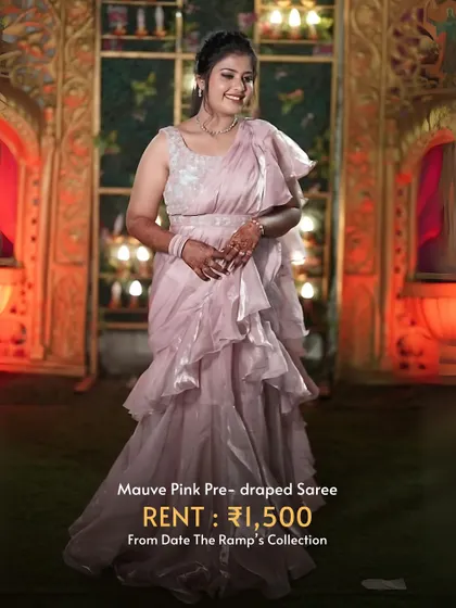 This mauve pink pre-draped saree with ruffles is incredibly stylish and available for a very affordable rental price.