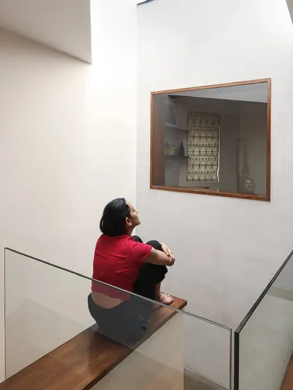 A moment of quiet reflection beneath a skylight. We use skylights not just to bring in light, but to bring in a sense of time. As the sun moves, the character of the room changes, connecting those inside to the natural rhythms of the day.