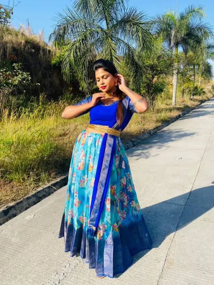 Another pose in the blue floral half saree, showcasing the beautiful print and vibrant colors.