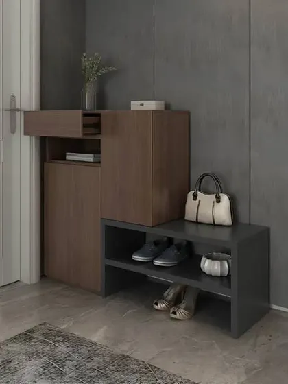 A modern and compact shoe storage solution for a small entryway. The design includes both a closed cabinet and open shelves for frequently used shoes.