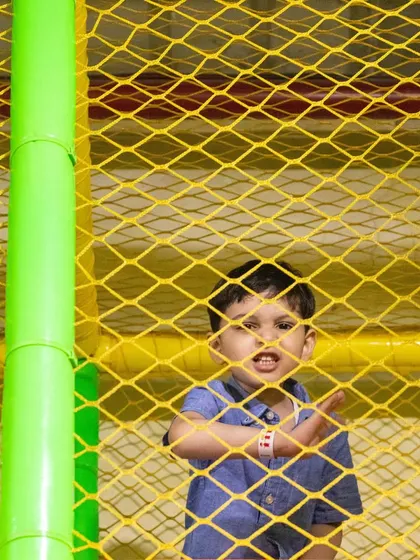 A peek through the safety netting of our multi-level play structure. Every corner is designed with your child's safety in mind.