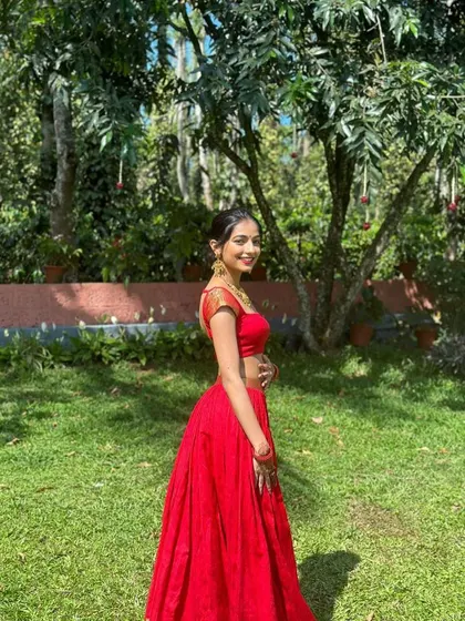 A side profile of the red crop top and skirt set, showing how the simple, clean lines create a flattering silhouette. The focus here is on the perfect fit and the vibrant color.