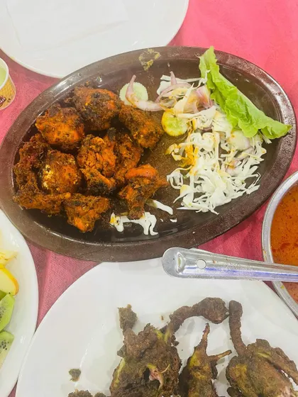 A serving of our Double Dum Chicken alongside other starters. This dish is slow-cooked to perfection, making the chicken incredibly tender and flavourful.