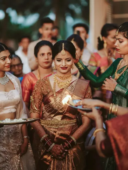 The bride's arrival is a moment of reverence and beauty. We captured this Mangalorean bride during her ceremony, with the warm glow of the aarti welcoming her.